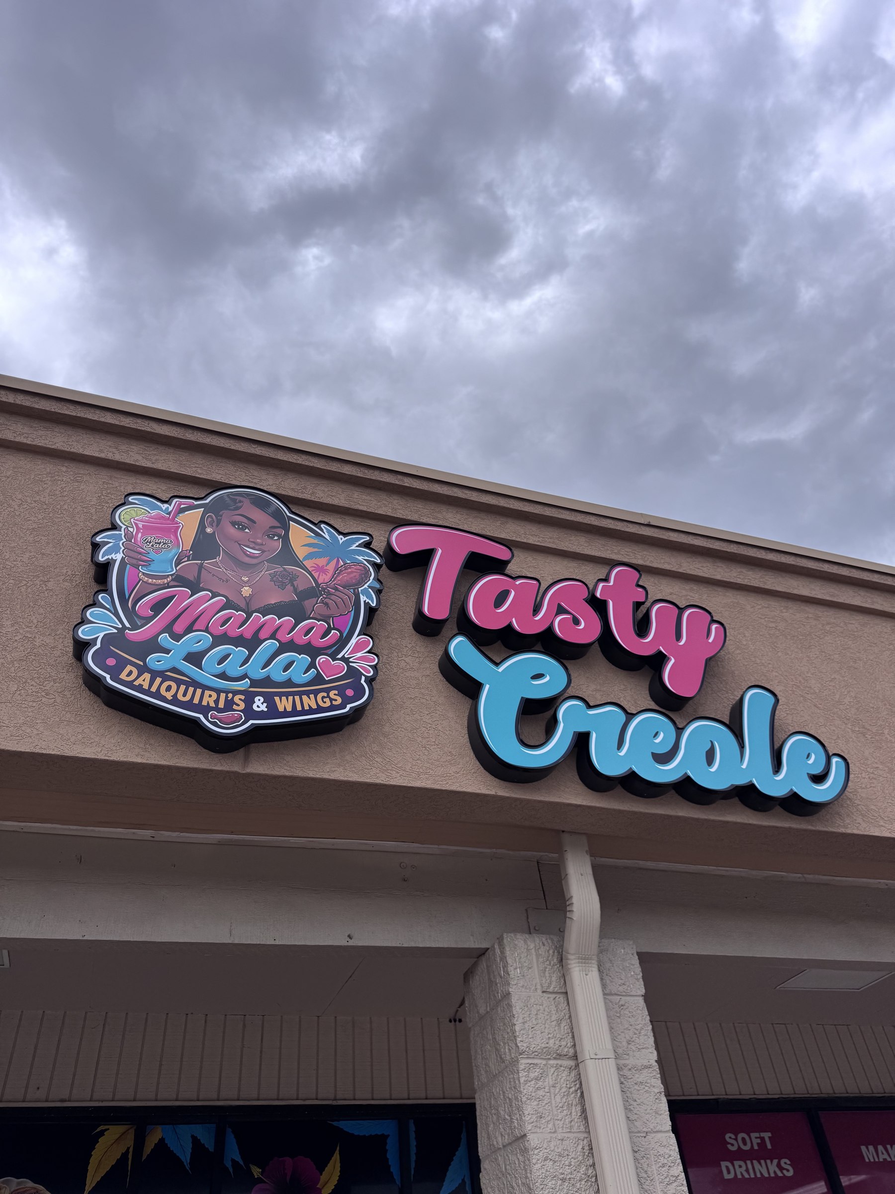 Storefront sign for Mama Lala and Tasty Creole in Houston, TX